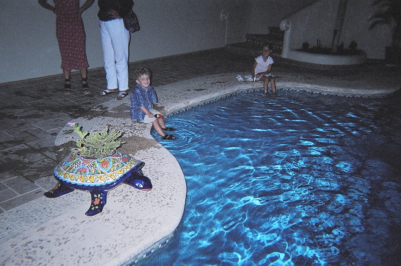 12200018.JPG - Dave and Katherine's by night. Barry and Kendall try the pool.